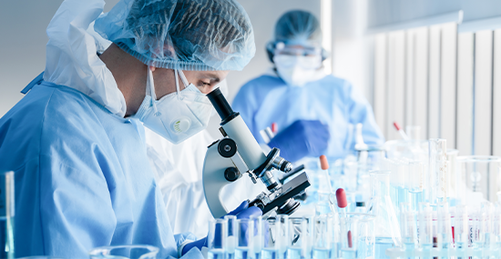 Doctor in UHS checking a microscope to examine a sample Doctor in UHS checking a microscope to examine a sample