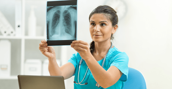 A medical professional examining an x-ray